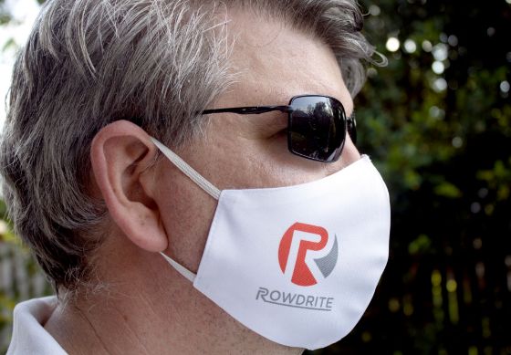 Side profile of a man wearing a face mask with the RowdRite logo on the side